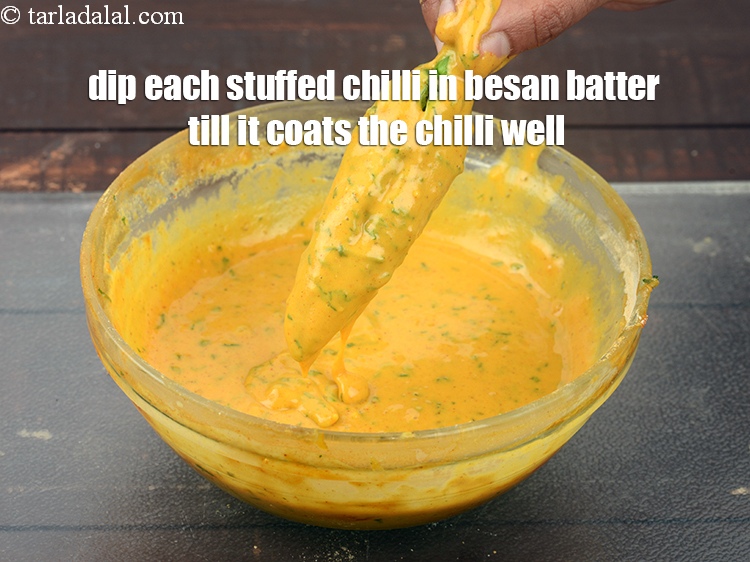 Step 22 – Heat oil in deep pan and dip each stuffed chilli in besan batter till it …
