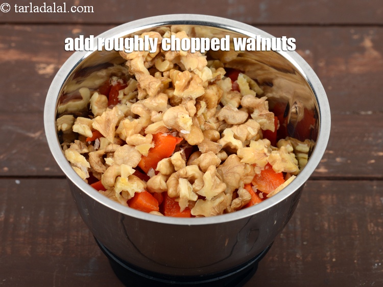 Step 11 – Add 1/2 cup roughly&nbsp;<a href="https://www.tarladalal.com/glossary-chopped-walnuts-785i">chopped walnuts (akhrot)</a>.