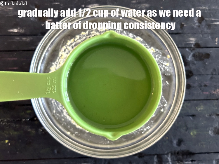Step 13 – Gradually&nbsp;add <strong>1/2&nbsp;cup of water </strong>as we need a batter of <strong>dropping consistency.</strong>