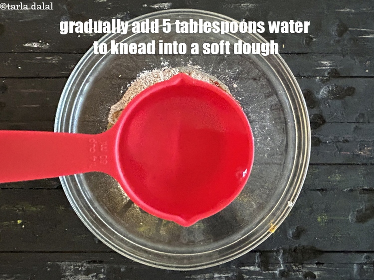 Step 13 – Gradually addng 5 tbsp of water, knead into a soft dough.