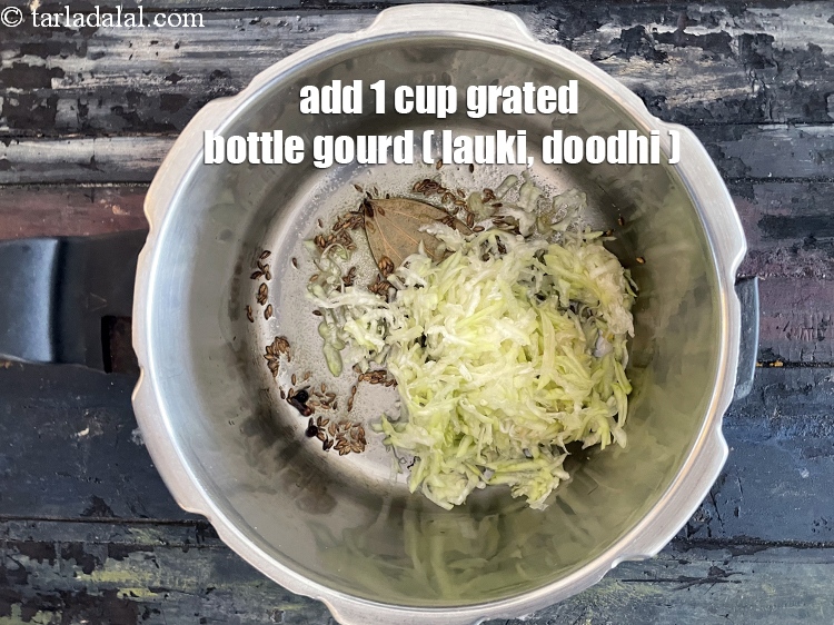 Step 20 – Add&nbsp;<meta charset="UTF-8" />1 cup&nbsp;<a href="glossary-grated-bottle-gourd-1048i">grated bottle gourd (doodhi / lauki)</a>.