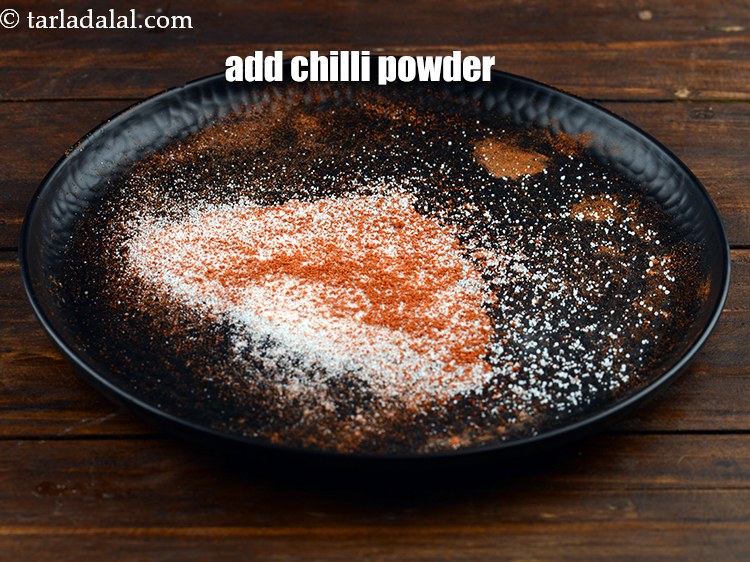 Step 10 – Add&nbsp;<a href="https://www.tarladalal.com/glossary-chilli-powder-red-chilli-powder-339i">chilli powder</a>.