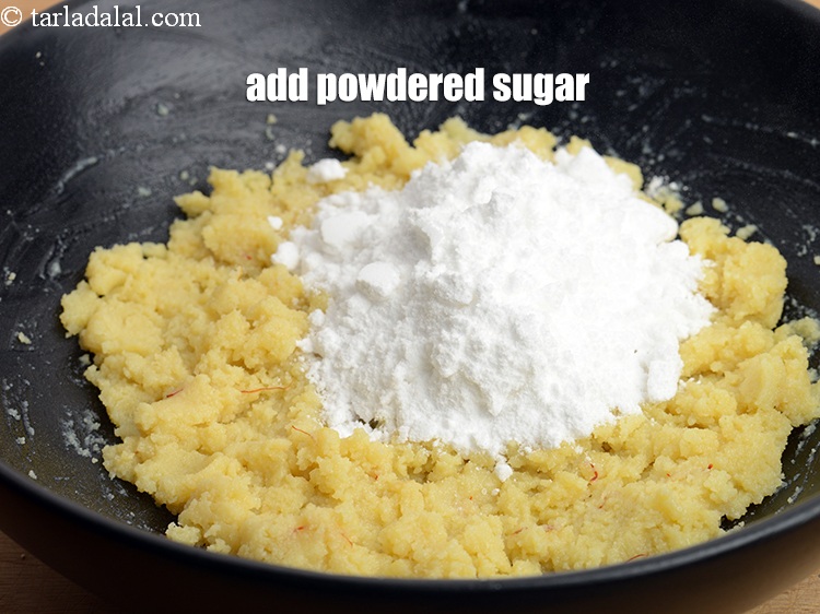 Step 11 – Add 5 tbsp <a href="https://www.tarladalal.com/glossary-powdered-sugar-280i">powdered sugar</a>.