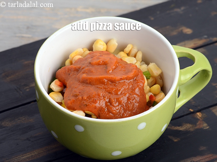 Step 11 – Add 2&frac12; tbsp <a href="https://www.tarladalal.com/glossary-pizza-sauce-1889i">pizza sauce</a>.