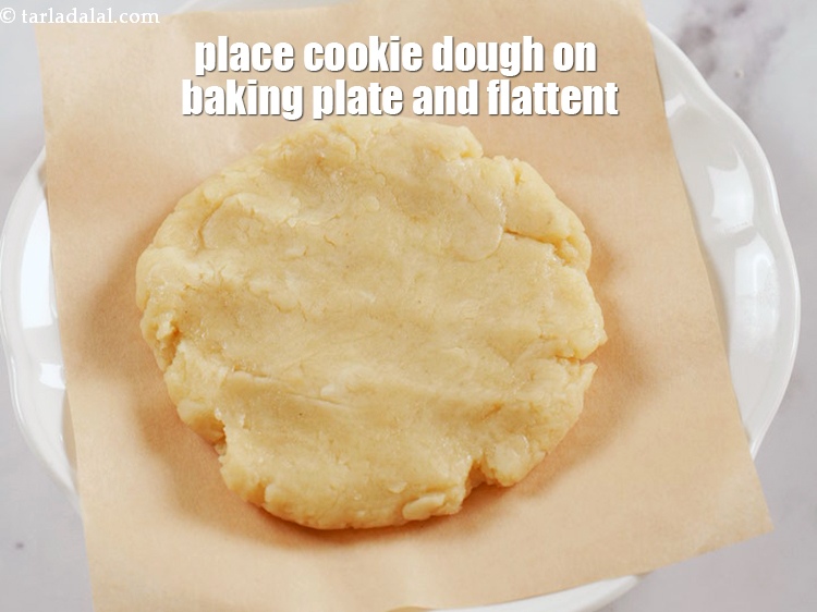 Step 11 – Place a portion of the cookie dough on baking paper lined plate. Flattent the cookie …