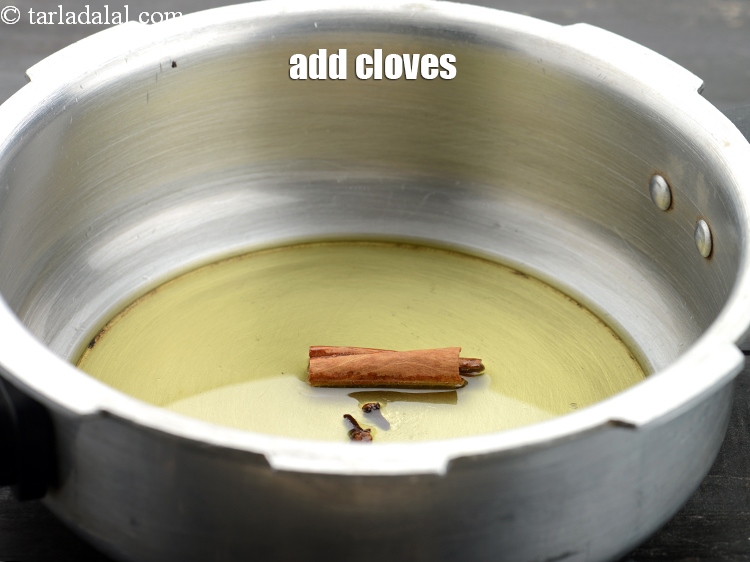 Step 16 – Add 2&nbsp;<a href="https://www.tarladalal.com/glossary-cloves-laung-lavang-322i">cloves (laung / lavang)</a>.