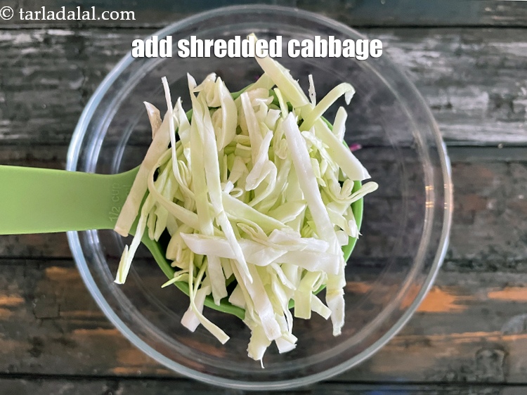 Step 13 – Add&nbsp;<!--%3Cmeta%20charset%3D%22UTF-8%22%20%2F%3E-->1/2 cup&nbsp;<a href="https://www.tarladalal.com/glossary-shredded-cabbage-763i">shredded cabbage</a>.