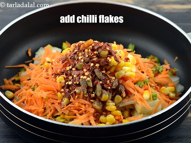 Step 10 – Add 1 tbsp&nbsp;<a href="https://www.tarladalal.com/glossary-dry-red-chilli-flakes-paprika-338i">dry red chilli flakes (paprika)</a>.&nbsp;