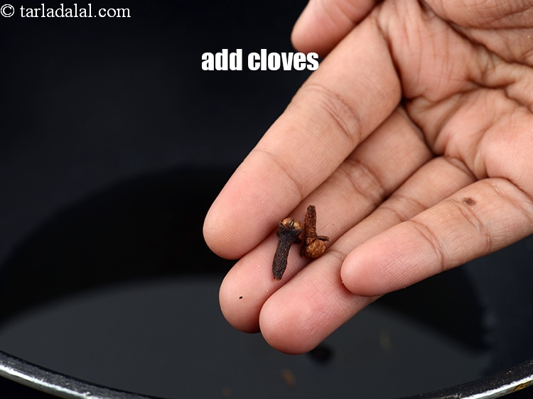 Step 12 – Add 2 <a href="https://www.tarladalal.com/glossary-cloves-laung-lavang-322i">cloves (laung / lavang)</a>.