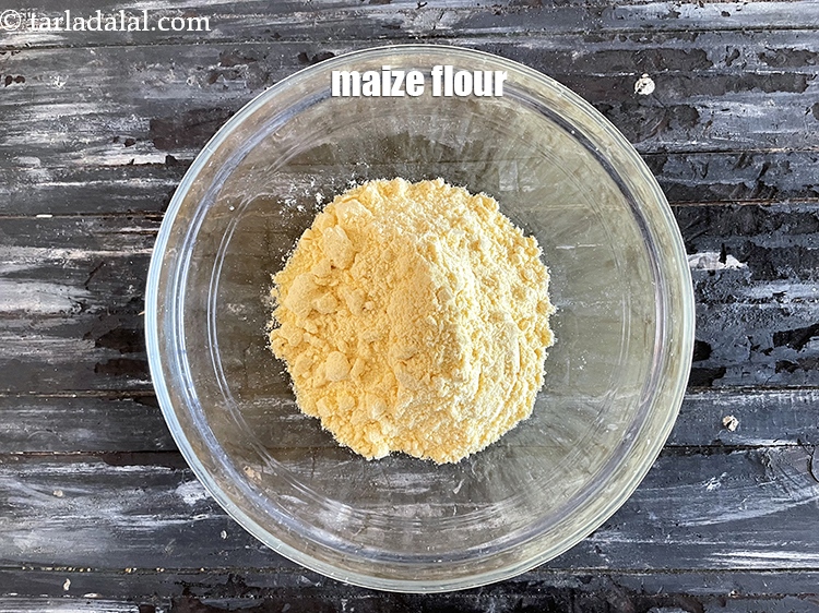 Step 5 – In a deep glass bowl put&nbsp;<meta charset="UTF-8" />1 cup&nbsp;<a href="glossary-maize-flour-makai-ka-atta-makki-ka-atta-162i">maize flour (makai ka atta)</a>.