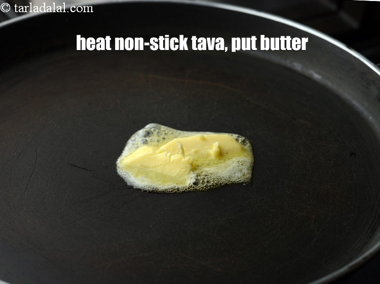 Step 19 – Heat a non-stick tava (griddle), put &frac12; tbsp of butter.