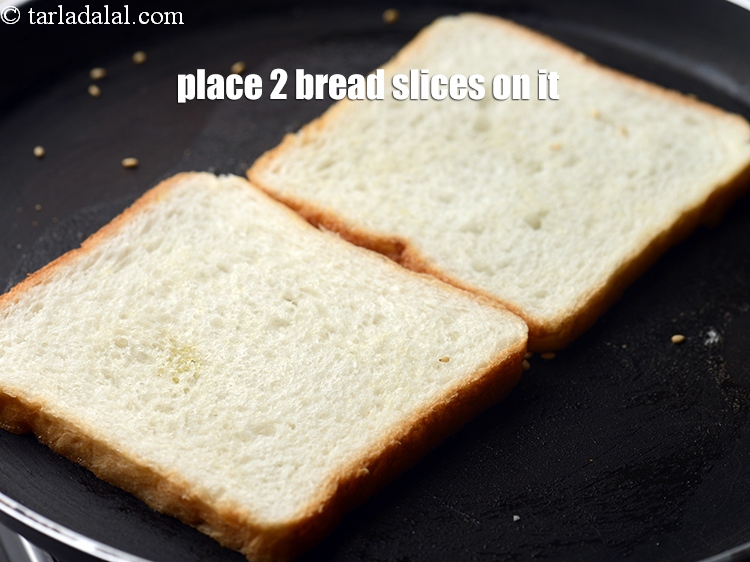 Step 21 – Place 2 <a href="https://www.tarladalal.com/glossary-bread-219i">bread slices</a> on it.