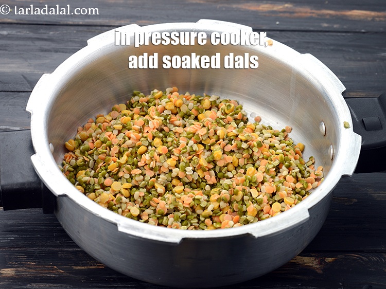 Step 11 – In a pressure cooker, add all the soaked dals.&nbsp;
