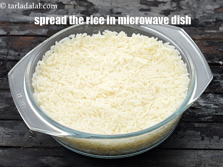 Step 23 – Spread the rice in a 175 mm. (7&rdquo;) diameter microwave safe baking dish with the …
