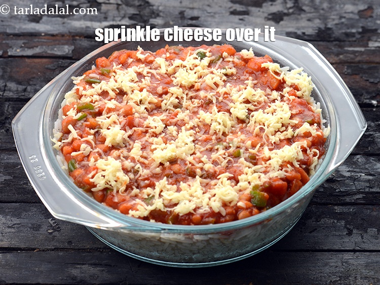 Step 26 – Sprinkle 2 tbsp&nbsp;<a href="https://www.tarladalal.com/glossary-grated-processed-cheese-868i">grated processed cheese</a>&nbsp;evenly over it.&nbsp;