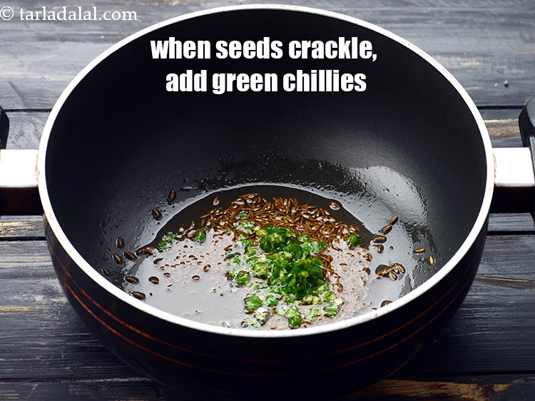 Step 19 – When the seeds crackle, add 1 tsp&nbsp;finely&nbsp;<a href="https://www.tarladalal.com/glossary-chopped-green-chilli-820i">chopped green chillies</a>.&nbsp;