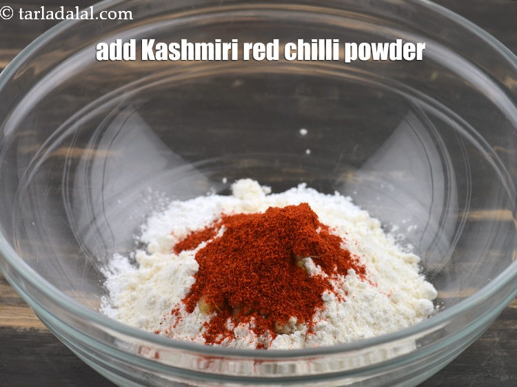 Step 6 – Add 1 tsp <a href="https://www.tarladalal.com/glossary-chilli-powder-red-chilli-powder-339i#ing_2684" target="_blank">kashmiri red chilli powder</a>.