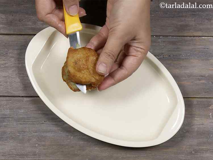 Step 21 – Cool the tikkis slightly and cut each tikki into 2 equal portions horizontally using a …