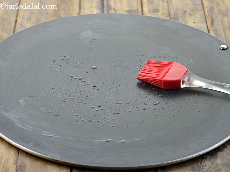 Step 23 – For making the <strong>Stuffed Moong Dal And Potato Rolls</strong>, heat a non-stick tava (griddle), grease …