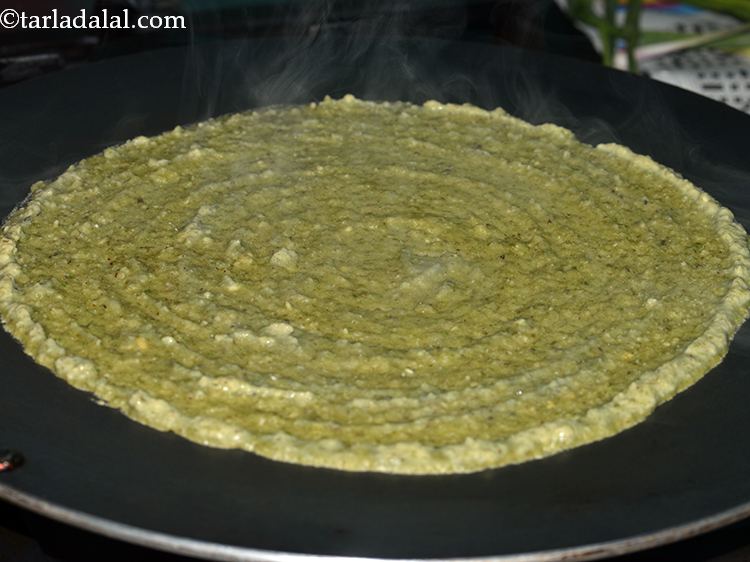 Step 25 – Pour &frac14;th of the batter on the tava (griddle).Spread in a circular motion to make …