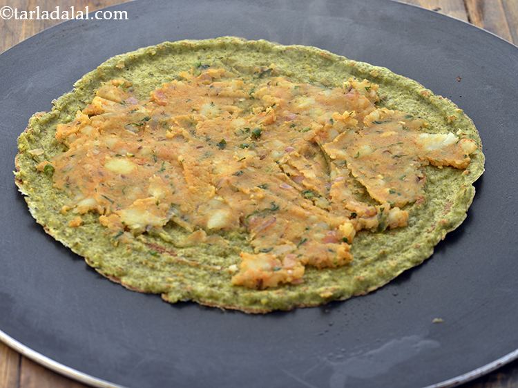 Step 28 – Spread a portion of the potato stuffing evenly over the chila using a spatula. You …