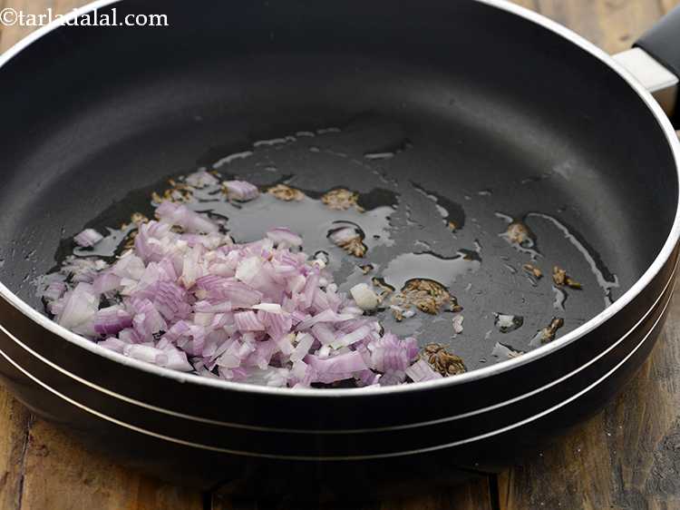 Step 17 – When the seeds crackle, add the onions.