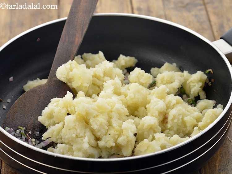 Step 19 – Add the potatoes. We have boiled, peeled and mashed the aloo before adding.