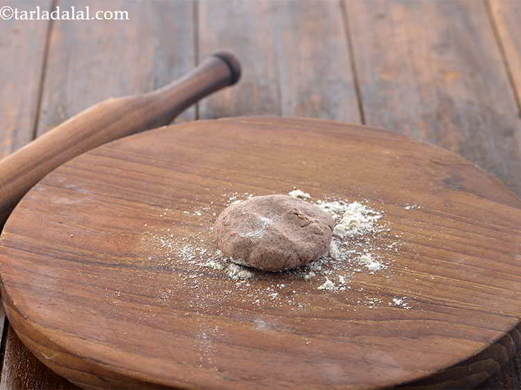 Step 18 – Take a portion of the dough and flatten it on the rolling board.