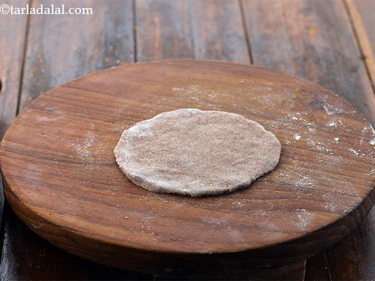 Step 19 – Roll a portion of the&nbsp;<strong>Stuffed Nachni Roti&nbsp;</strong>dough into 100 mm. (4") diameter circle using a …
