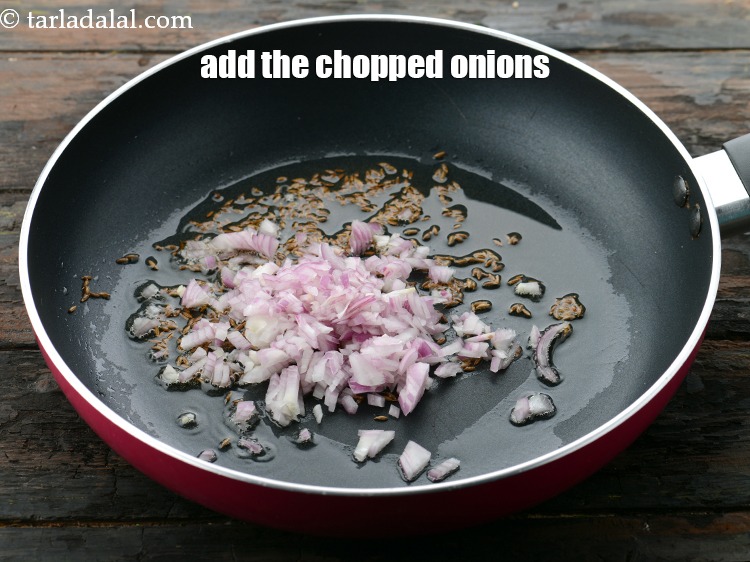 Step 21 – Once the seeds crackle add&nbsp;1/4 cup&nbsp;finely&nbsp;<a href="https://www.tarladalal.com/glossary-chopped-onions-722i">chopped onions</a>.&nbsp;