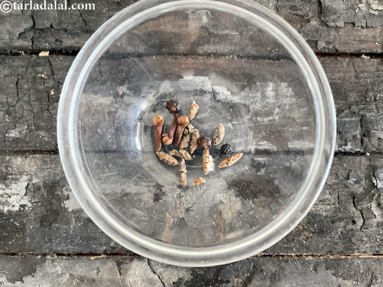 Step 11 – Take 3&nbsp;<a href="glossary-cardamom-elaichi-262i">cardamoms</a>&nbsp;and peel them the covering woth your hands to get cardamom pods or …