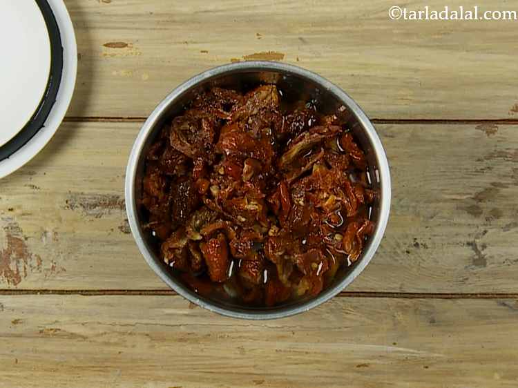 Step 12 – Add salt and ? cup of water in a mixer and blend into a paste.