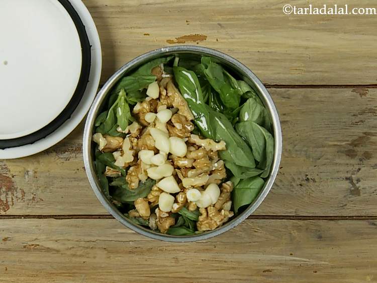 Step 4 – Now add chopped garlic. It livens up the pesto dip with unique aroma and flavor.