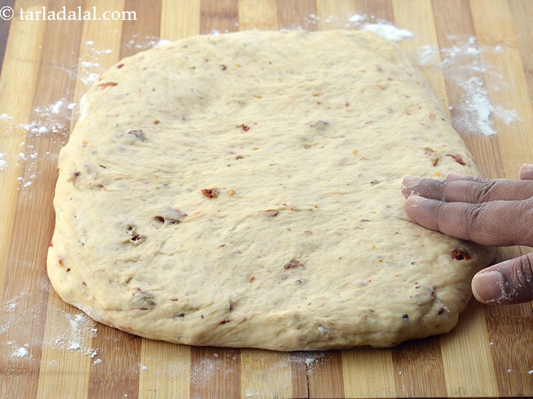 Step 45 – Place the dough over it and stretch the dough with your hands and make it …