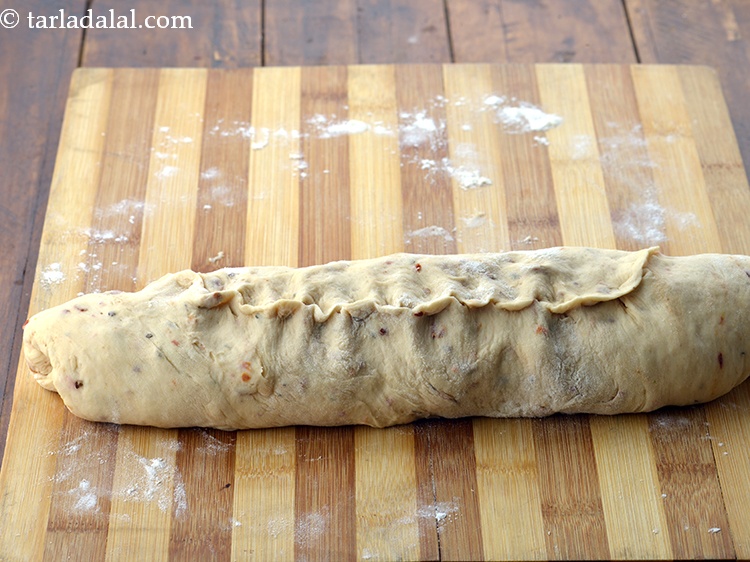 Step 46 – Roll the dough to make a 200 mm. (8&rdquo;) long cylindrical roll and pinch the …