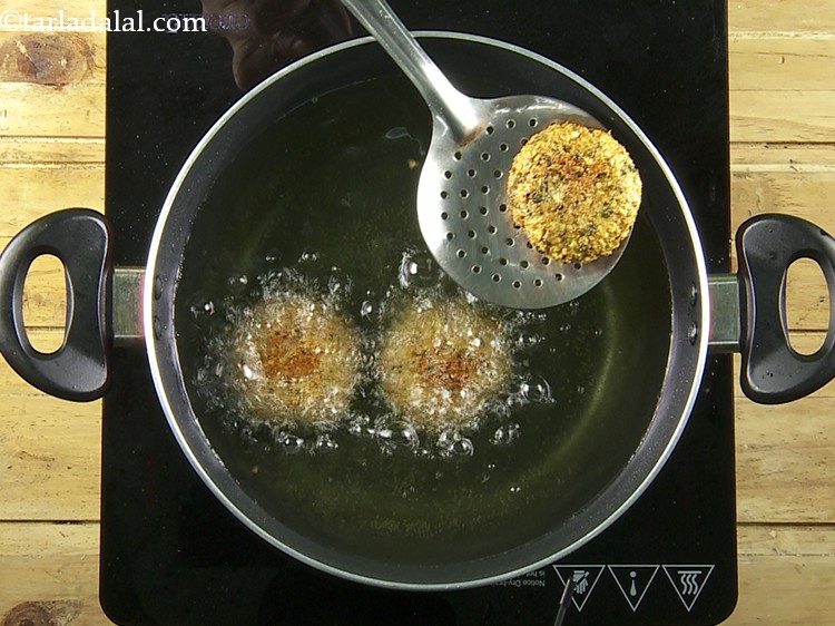 Step 24 – Flip and deep-fry the&nbsp;<strong>Yam Chana Dal Tikkis</strong>&nbsp;on a medium flame till they turn golden brown …
