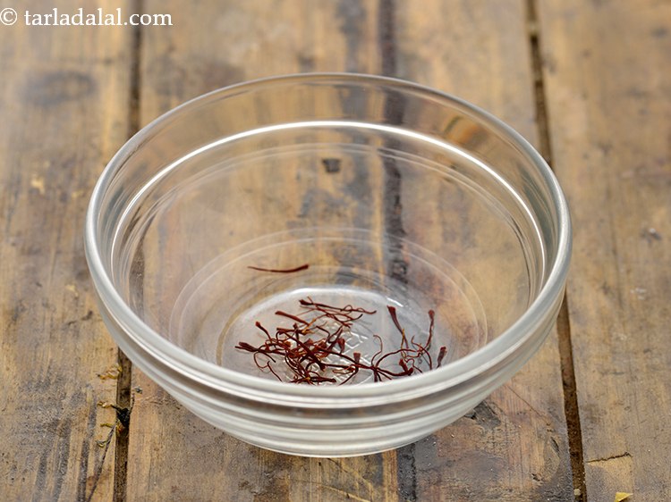 Step 2 – To prepare sugar syrup for <strong>sweet boondi</strong>, in a small bowl, take some saffron strands.