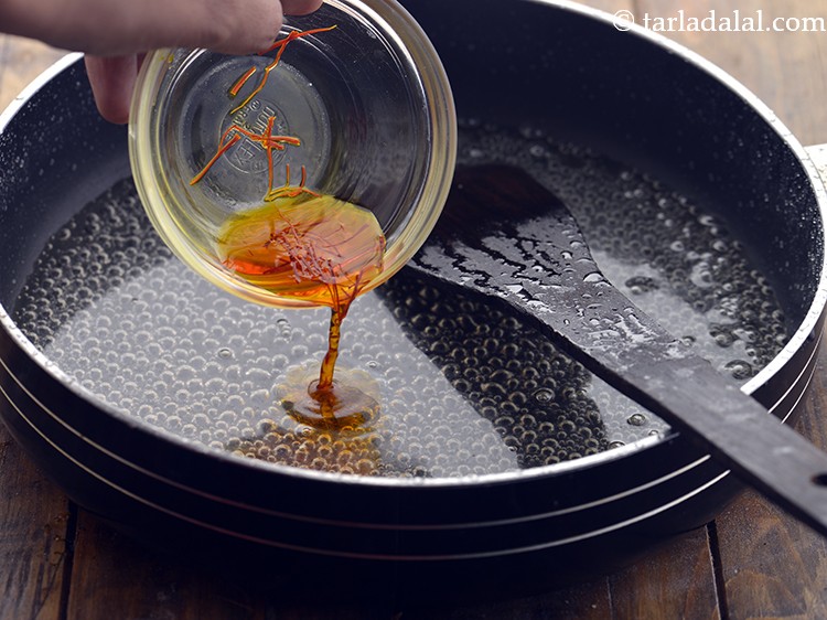 Step 9 – Add the saffron-water mixture. You can even flavour the sugar syrup with cardamom powder.