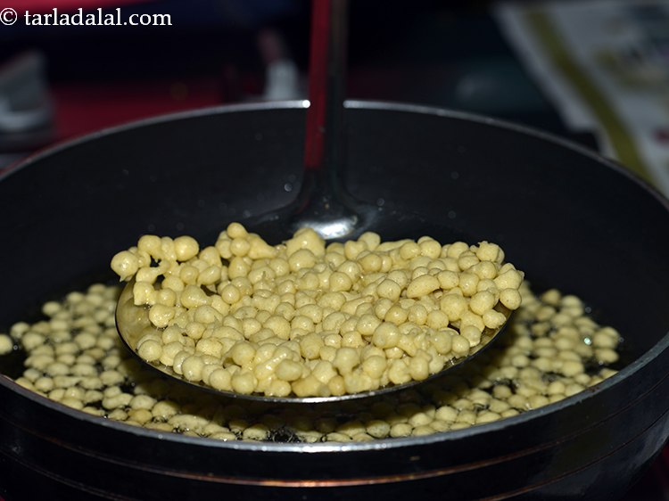 Step 17 – Remove them using a slotted spoon and directly transfer the prepared boondi in warm sugar …