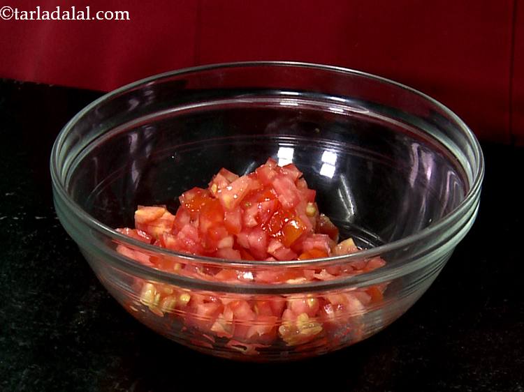 Step 13 – For the uncooked salsa topping,&nbsp; in a bowl take finely chopped tomatoes.