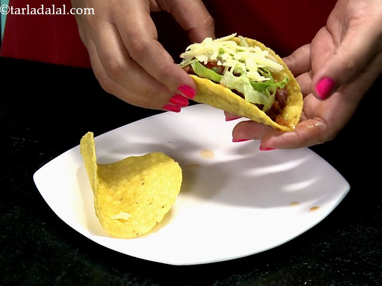 Step 26 – And finally top it with grated processed cheese to the&nbsp;<strong>Mexican Tacos</strong>.