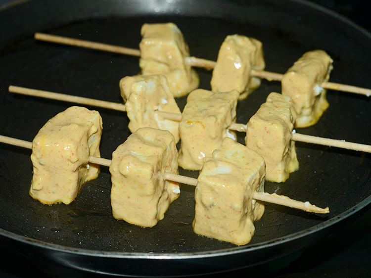 Step 21 – Place the marinated paneer cubes on the tava carefully.
