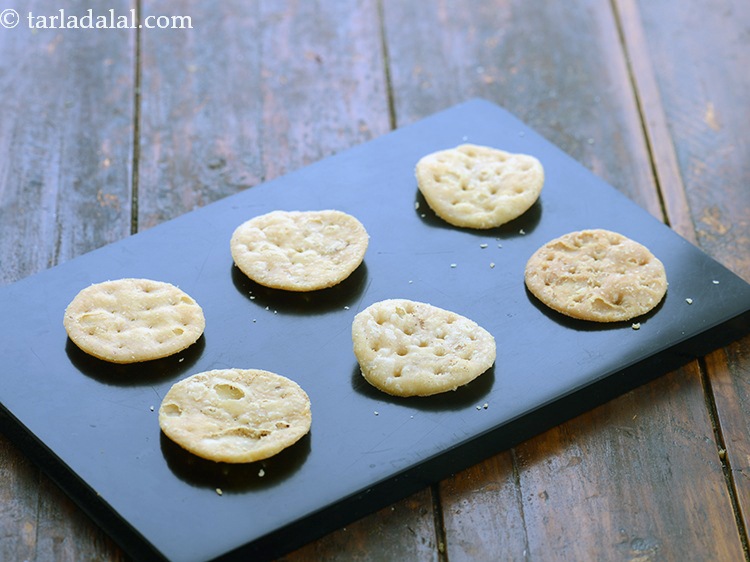 Step 27 – To assemble tangy rajma sev puri, just before serving, arrange 6 papdis on a serving …