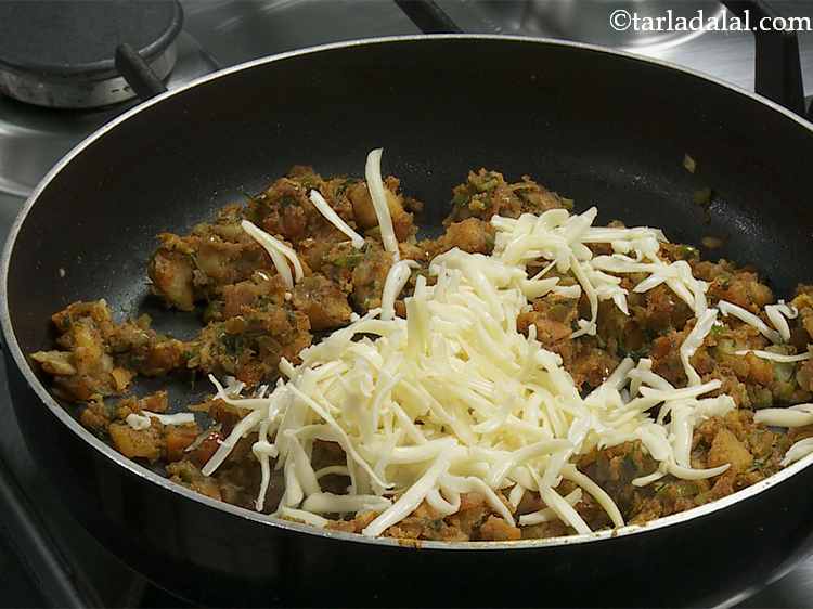 Step 8 – Switch off the flame, add the cheese. Be generous while adding cheese as we want …