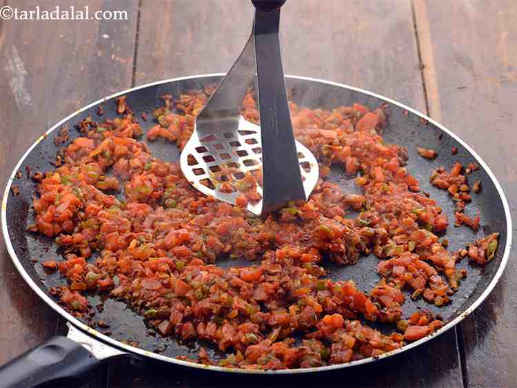 Step 23 – Using a potato masher, mash the vegetables lightly.