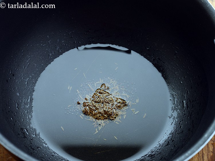 Step 15 – When the seeds crackle, add the cumin seeds.