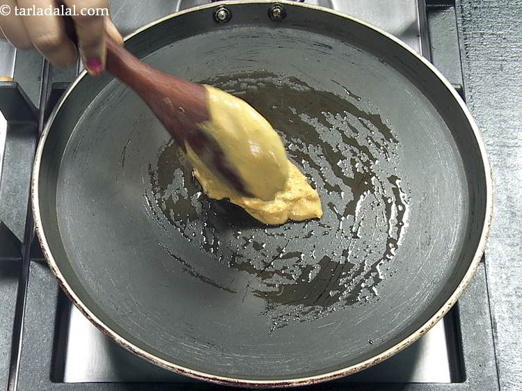 Step 17 – Pour a ladleful of the batter on the tava (griddle).