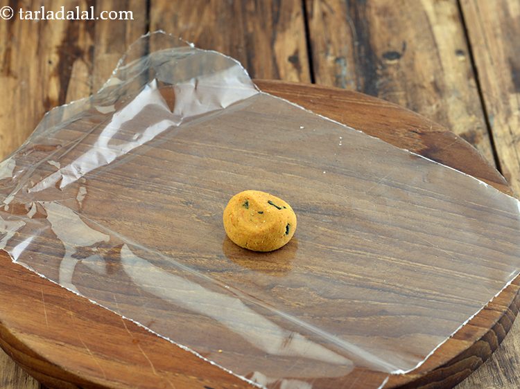 Step 20 – Flatten 1 portion of the dough on it.