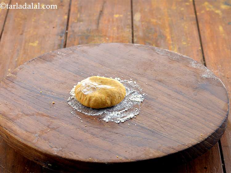 Step 14 – Dip one portion of the dough in flour, shake off the excess flour and flatten …