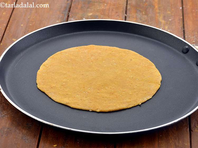 Step 16 – Heat a non-stick tava (griddle) and place the <strong>thepla</strong> on it.&nbsp;